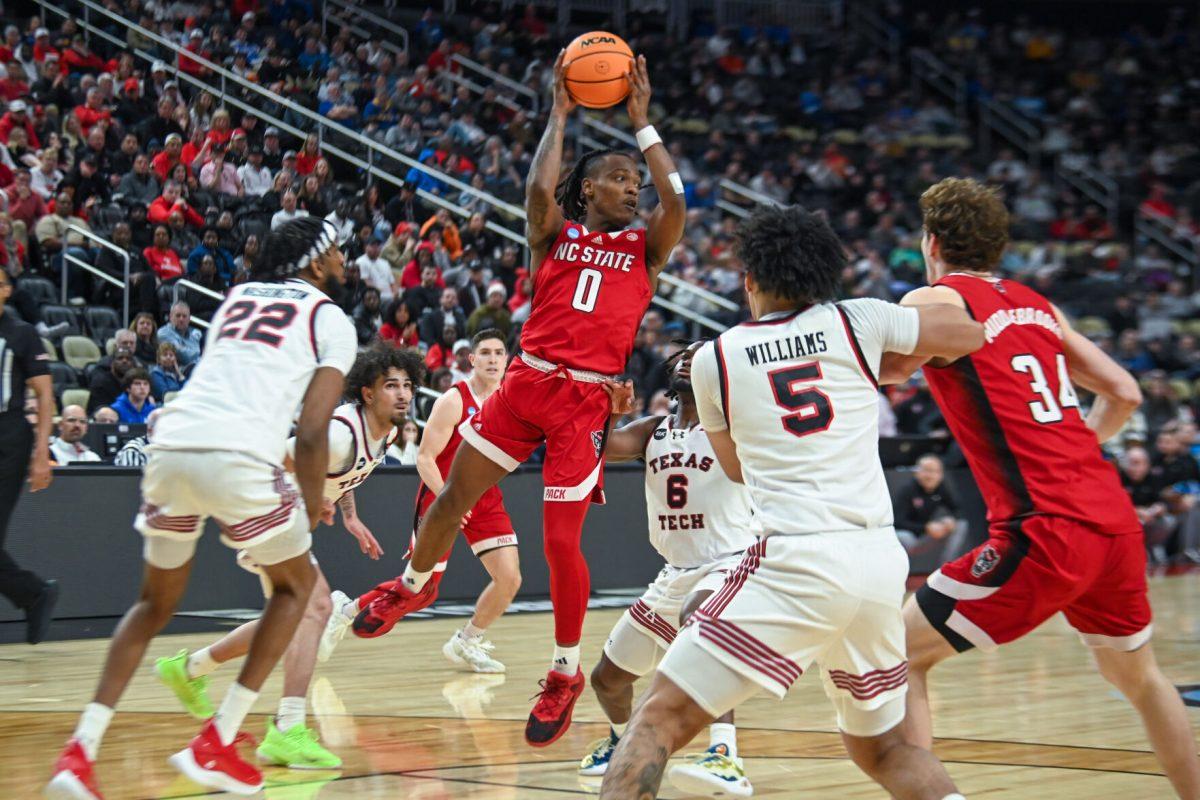 Graduate Guard DJ Horne passes the ball during the NCAA March Madness first round game against the Texas Tech Red Raiders in PPG Paints Arena on Thursday, March 21, 2024. Horne had 16 points during the game. NC State beat Texas Tech 80-67.