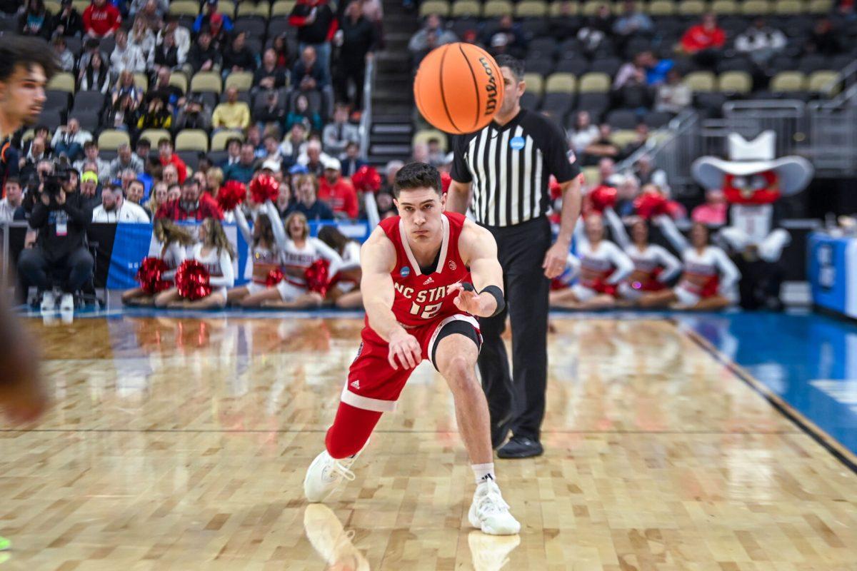 Graduate Guard Michael O'Connell passes the ball during the NCAA March Madness first round game against the Texas Tech Red Raiders in PPG Paints Arena on Thursday, March 21, 2024. O'Connell had six assists. NC State beat Texas Tech 80-67.