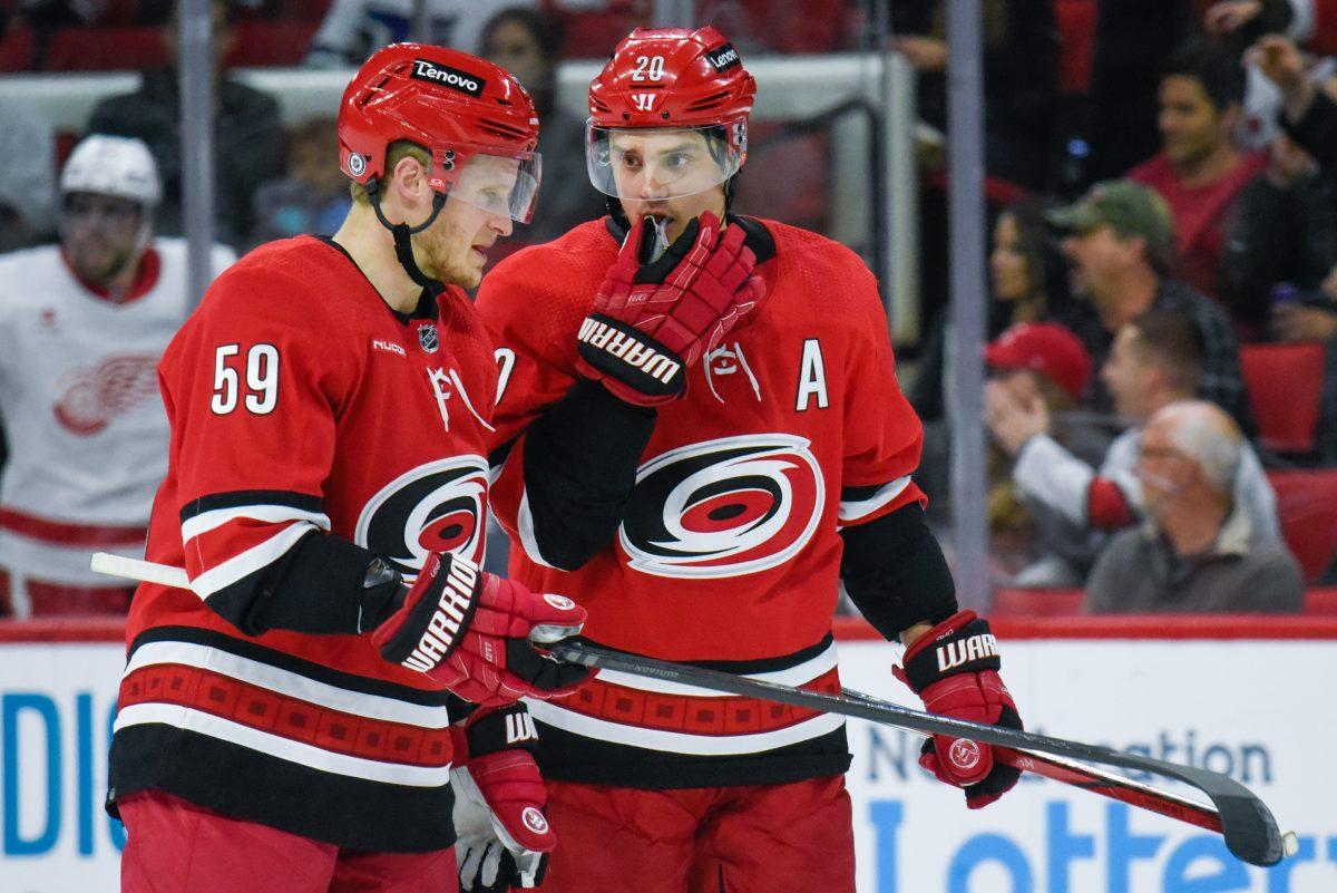 Centers Jake Guentzel and Sebastian Aho talk during a break in the game against the Detroit Red Wings in PNC Arena on Thursday, March 28, 2024. The Hurricanes defeated the Red Wings 4-0.