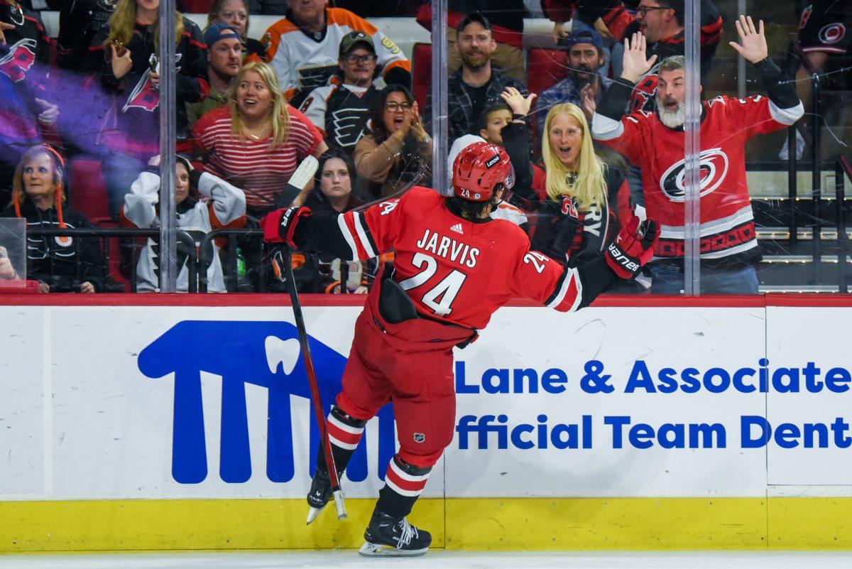 Center Seth Jarvis celebrates with fans after scoring a game-winning goal in overtime during the game against the Philadelphia Flyers in PNC Arena on Thursday, March 21, 2024. The Hurricanes defeated the Flyers 3-2.