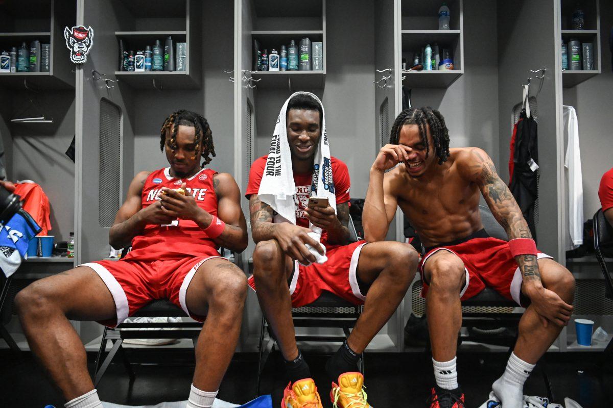 Junior guard Kam Woods, junior forward Ernest Ross and junior guard Breon Pass sit together in the locker room after the Sweet 16 game of the NCAA Tournament against Marquette at American Airlines&#160;Center in Dallas on Friday, March 29, 2024. NC State beat Marquette 67-58.