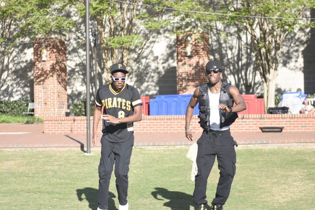 Kaleb Hall, a second-year studying communication and Lance Patterson, a second-year studying business administration, dance together at the Stomp the Yard Darty in Harris Field on Friday, April 12, 2024. Hall and Patterson are members of the Eta Omicron chapter of Alpha Phi Alpha Fraternity.