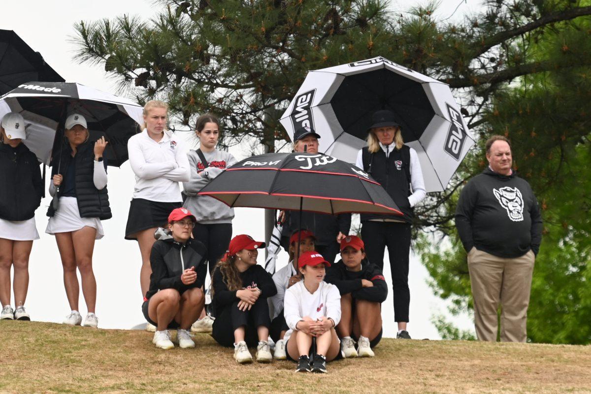 The NC State women's golf team and coaches watch on during the Wolfpack Match Play at Lonnie Poole Golf Course on Tuesday, April 9, 2024. The Wolfpack finished sixth overall in its final regular season stitch.