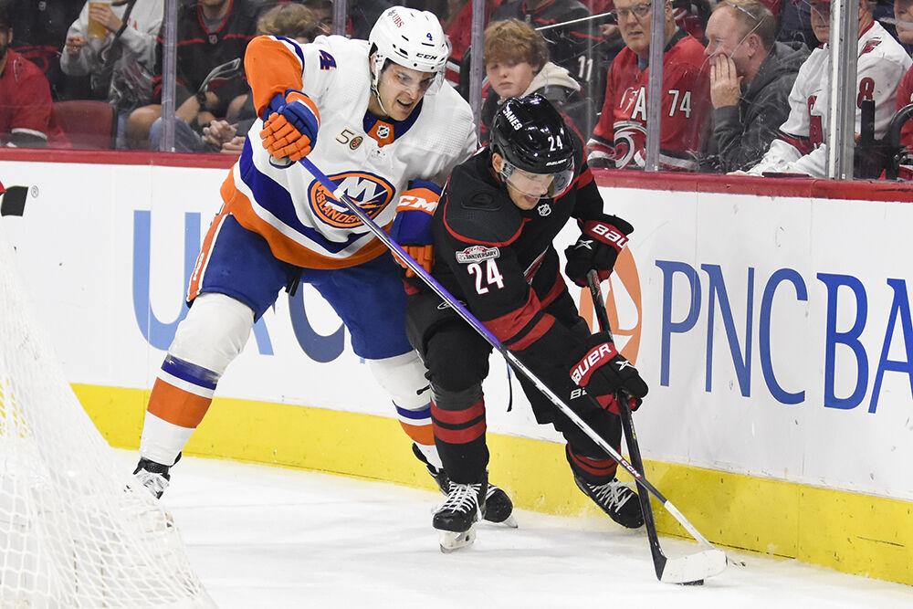 Carolina Hurricanes center Seth Jarvis dribbles the puck up ice away from an opponent during the game against the New York Islanders in PNC Arena on Sunday, April 2, 2023. Jarvis had one shot on goal throughout the game. The Hurricanes won 2-1.