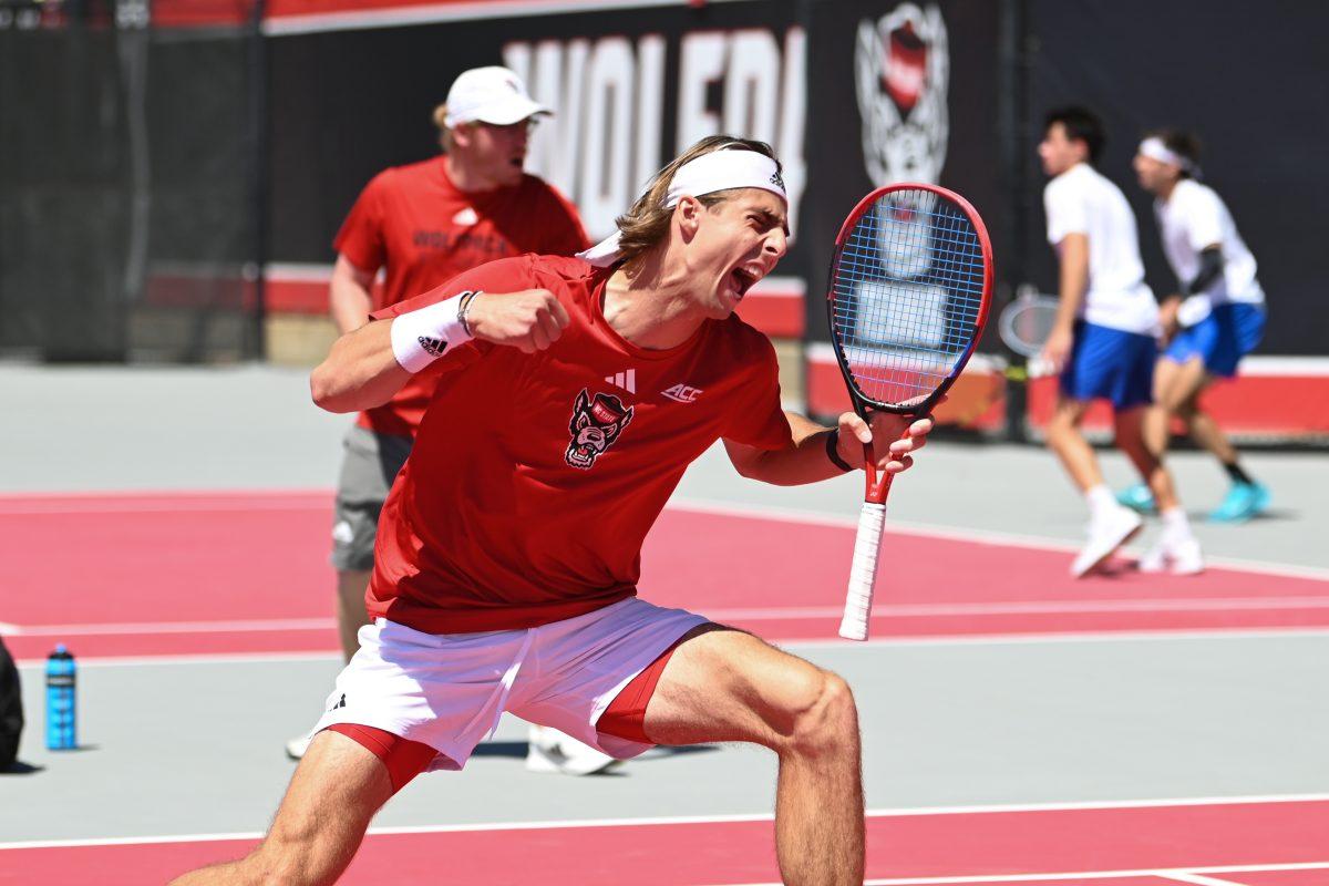Senior Robin Catry celebrates a point during the match against Duke at Dail Outdoor Tennis Stadium on Sunday, April 14, 2024. Catry won his doubles match. NC State beat Duke 4-2.