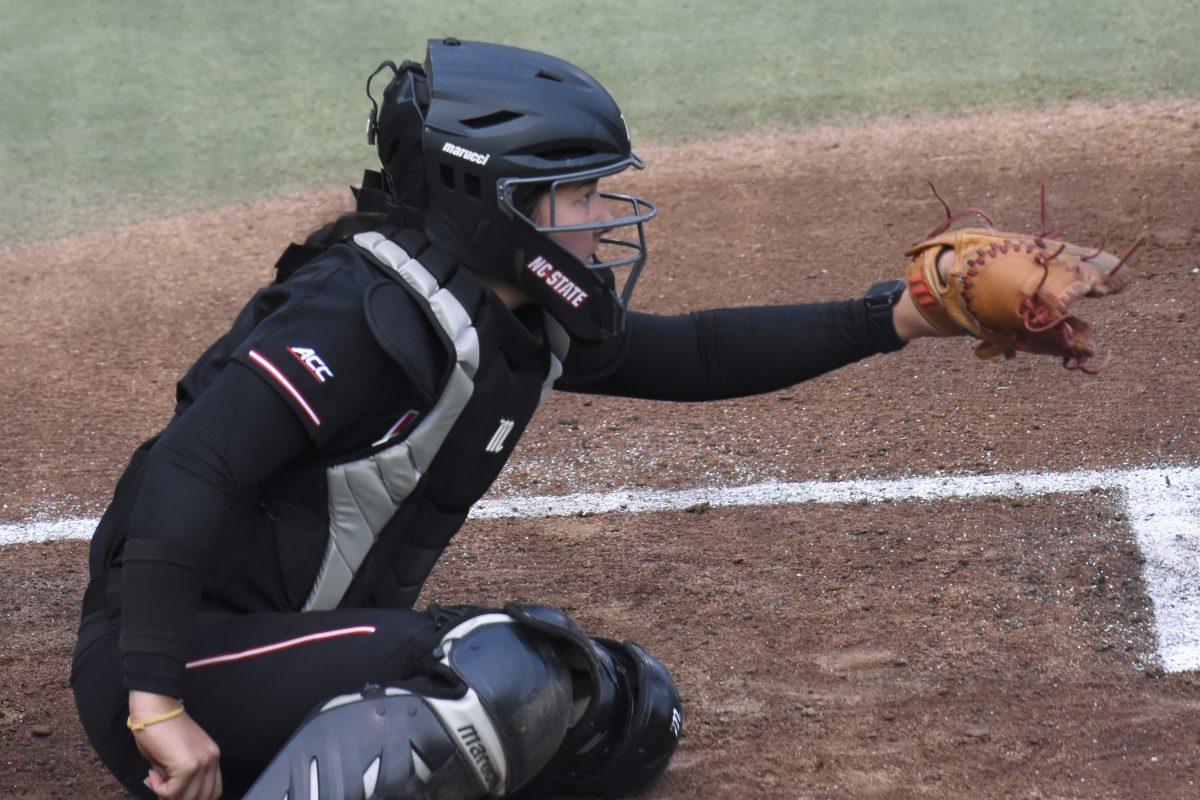 Sophomore catcher Amanda Hasler keeps her stance steady during the second game of the doubleheader against Queens University at Dail Softball Stadium on Tuesday, April 9, 2024. Hasler had two at bats with two hits and one run. NC State won the game 8-1.