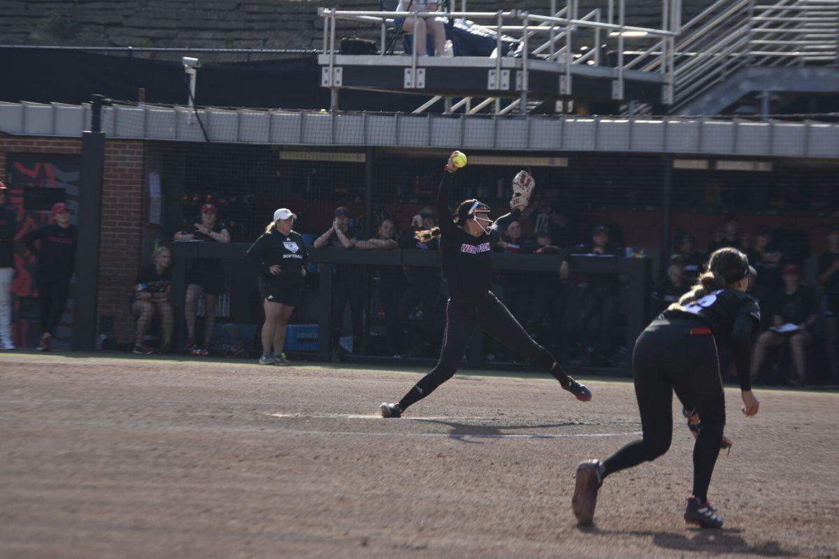 Freshman pitcher Kayla Fekel rolls their foot while winding up for a pitch at the Dali Softball Stadium against Presbyterian on Saturday, April 20, 2024. NC State won against Presbyterian 9-0 in five innings.