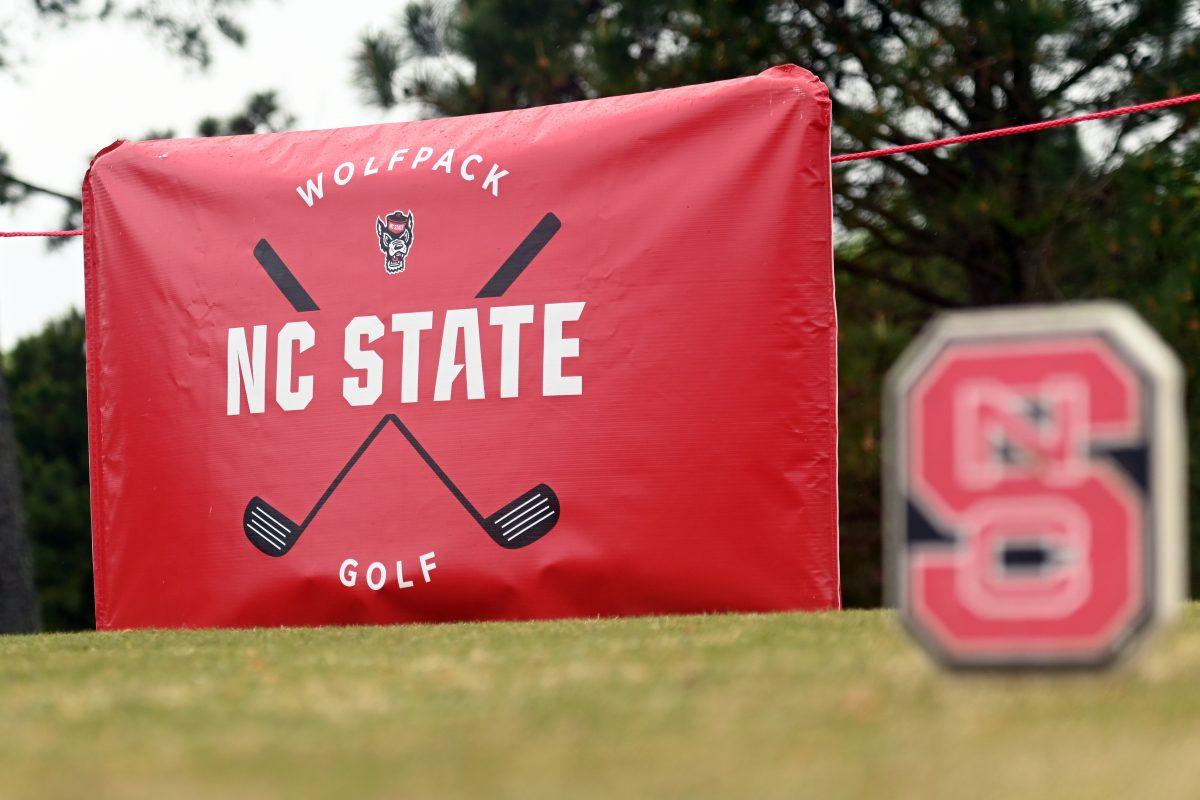 An NC State Wolfpack Golf banner hangs in the distance during the Wolfpack Match Play at Lonnie Poole Golf Course on Tuesday, April 9, 2024. The Wolfpack finished sixth overall in its final regular season stitch.