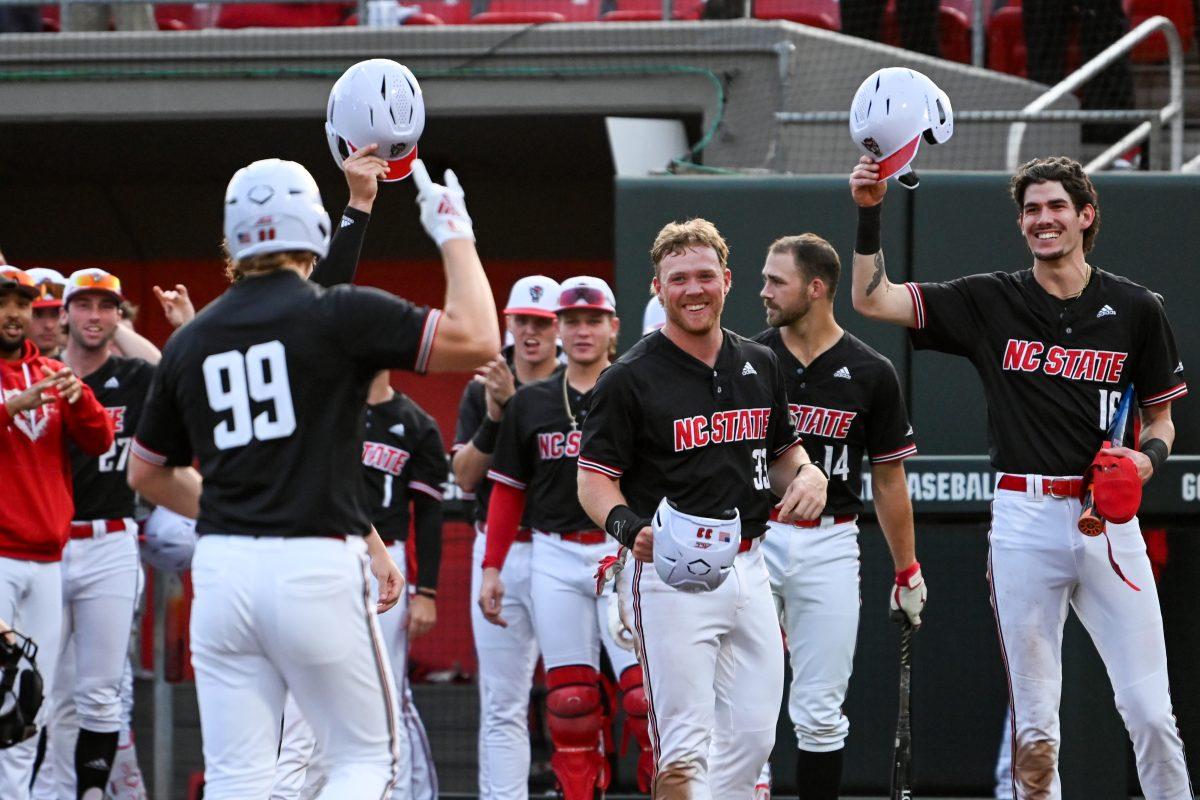 The team celebrates as graduate infielder Alec Makarewicz approaches home plate after hitting a home run during the game against Ball State at Doak Field at Dail Park on Friday, April 26, 2024. Makarewicz scored one run and had four RBIs. NC State beat Ball State 10-2.
