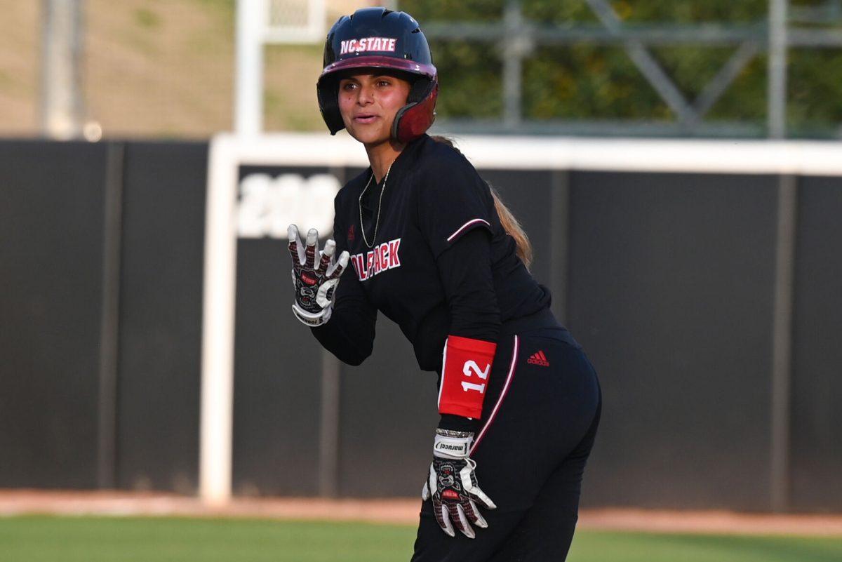 Freshman infielder Raylee Leiman signals to her coach after noticing the incorrect score board during the game against Elon at Dail Softball Stadium on Tuesday, April 2, 2024. Leiman had one at bat and one run. NC state won the game 12-2.