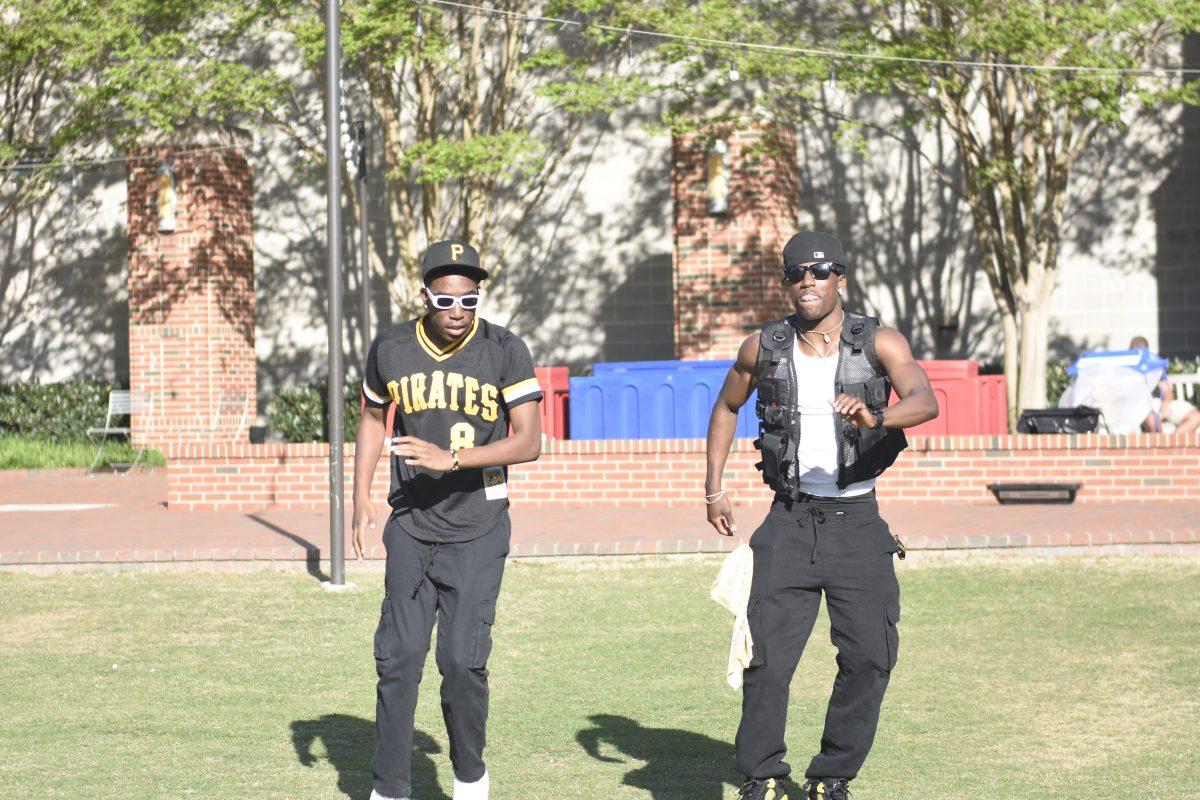 Kaleb Hall, a second-year studying communication and Lance Patterson, a second-year studying business administration, dance together at the Stomp the Yard Darty in Harris Field on Friday, April 12, 2024. Hall and Patterson are members of the Eta Omicron chapter of Alpha Phi Alpha Fraternity.