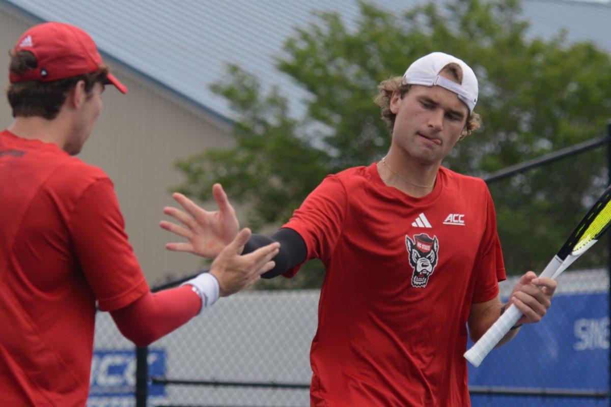 Junior Joseph Wayand (left) and sophomore Martin Borisiouk (right) high-five during the ACC Tournament quarterfinals match against Florida State at Cary Tennis Park on Friday, April 19, 2024. NC State lost 4-0 to Florida State.