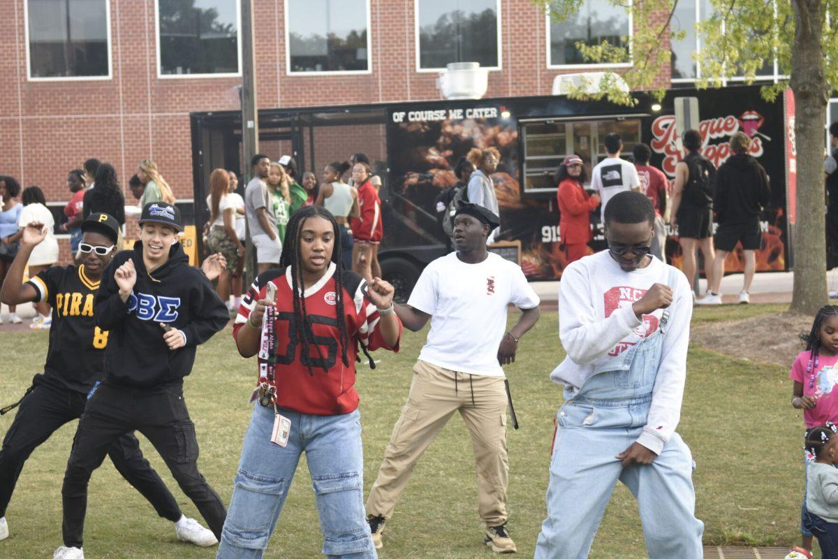 Students dance together at the Stomp the Yard Darty in Harris Field on Friday, April 12, 2024. The fifth main event for Pan-Afrikan Week included live music, food trucks and a performance by Code Red.