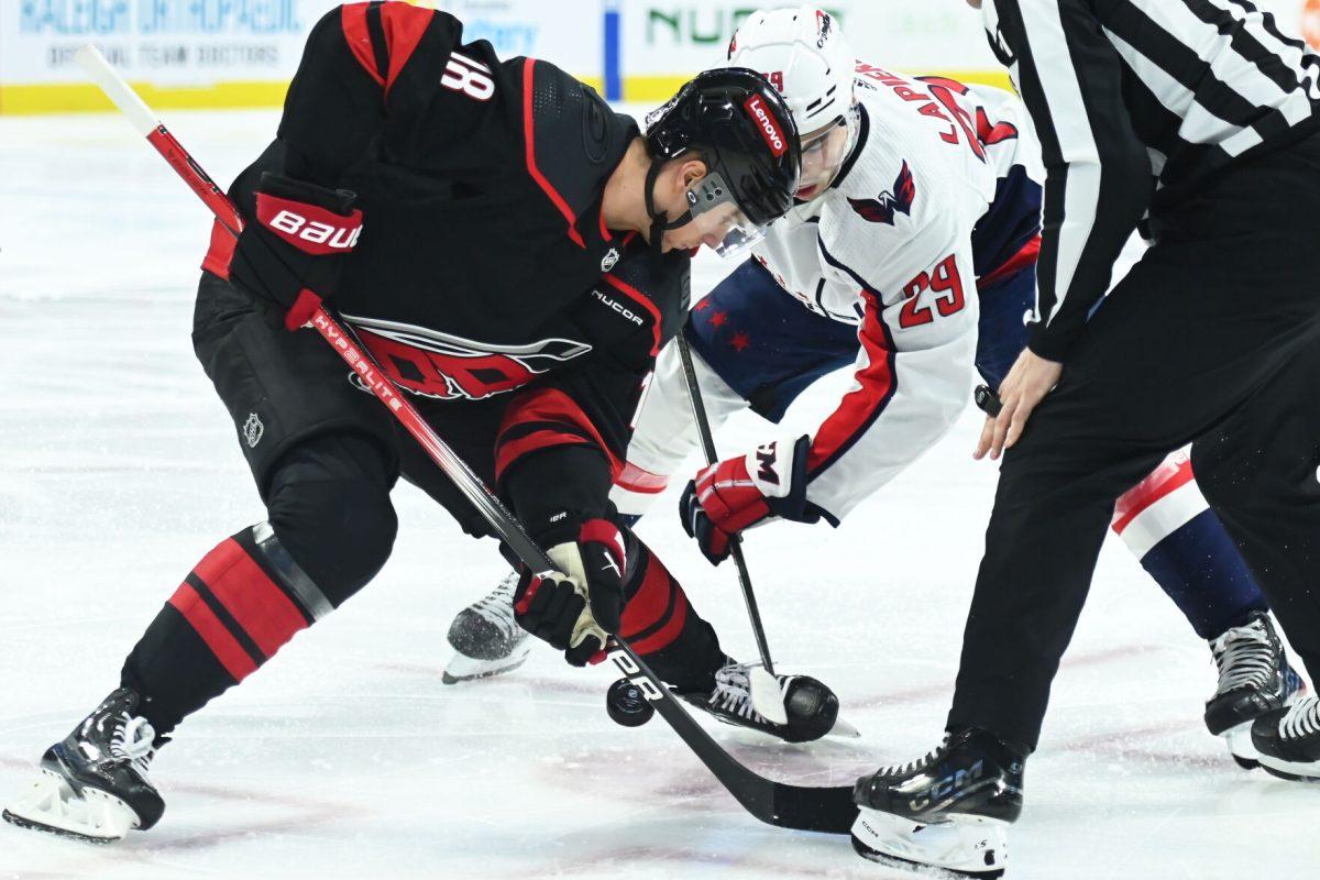 Center Jack Drury battles for the puck during the Carolina Hurricanes game versus the Washington Capitals at PNC Arena on Friday, April 5, 2024. The Hurricanes beat the Capitals 4-2.