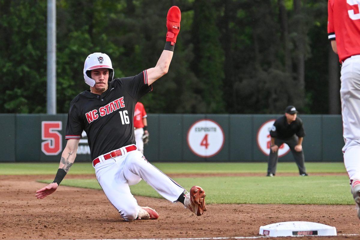 Sophomore outfielder Eli Serrano slides into third base during the game against Ball State at Doak Field at Dail Park on Friday, April 26, 2024. Serrano scored three runs and had one hit. NC State beat Ball State 10-2.