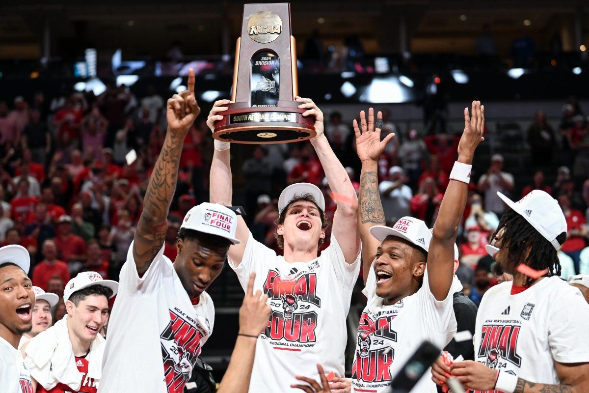 Junior forward Ben Middlebrooks lifts the South Regional trophy after winning the NCAA Tournament Elite 8 game against Duke at American Airlines Center in Dallas on Sunday, March 31, 2024. Middlebrooks scored seven points and made five rebounds. NC State beat Duke 76-64 to advance to the Final Four.
