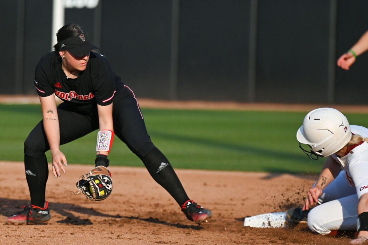Senior infielder Kaylee Lambrecht attempts to tag an Elon player during the game against Elon at Dail Softball Stadium on Tuesday, April 2, 2024. Lambrecht had one at bat and two runs. NC state won the game 12-2.