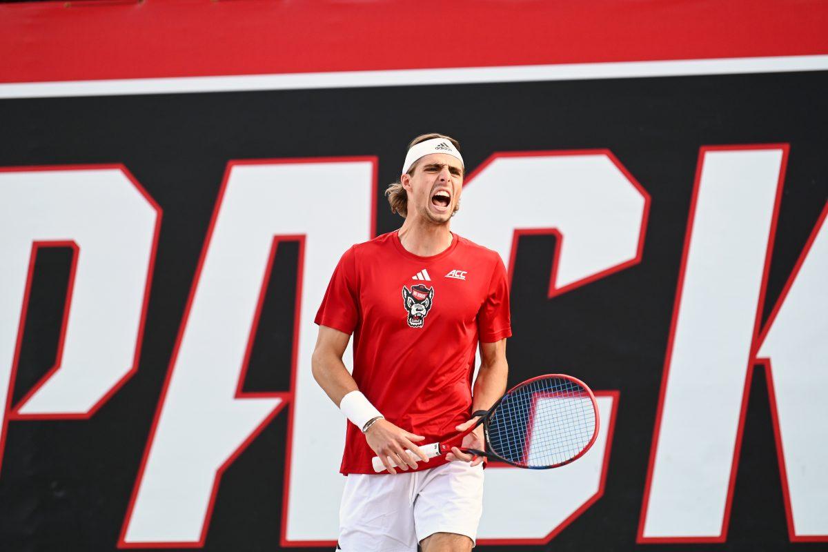 Senior Robin Catry celebrates after scoring a point during the match against UNC-Chapel Hill at Dail Outdoor Tennis Stadium on Friday, April 12, 2024. Catry won his doubles match 6-3 and his singles match went unfinished. NC State beat Chapel Hill 4-0.