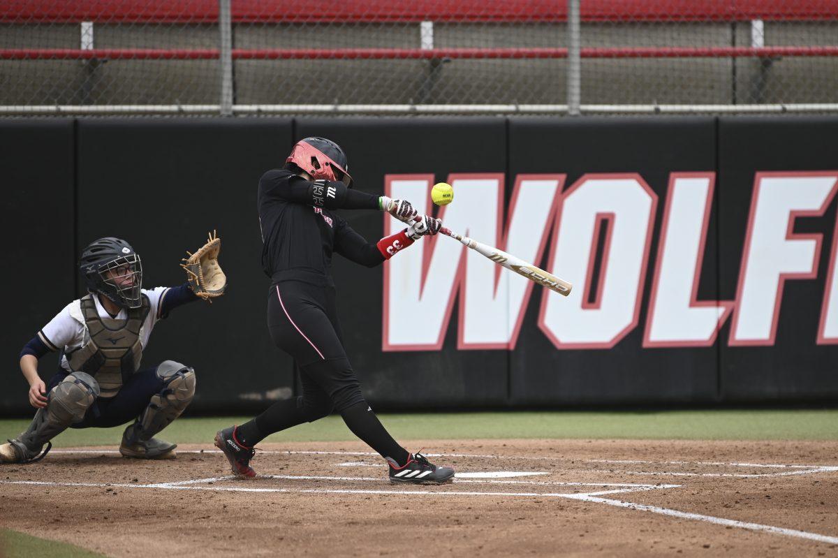 Junior infielder Alaina Smith hits during the Wolfpack's softball game against the Queens University Royals at the Dail Softball Stadium on Tuesday, April 9, 2024. The Wolfpack defeated the Royals in the first game of the doubleheader 7-1.