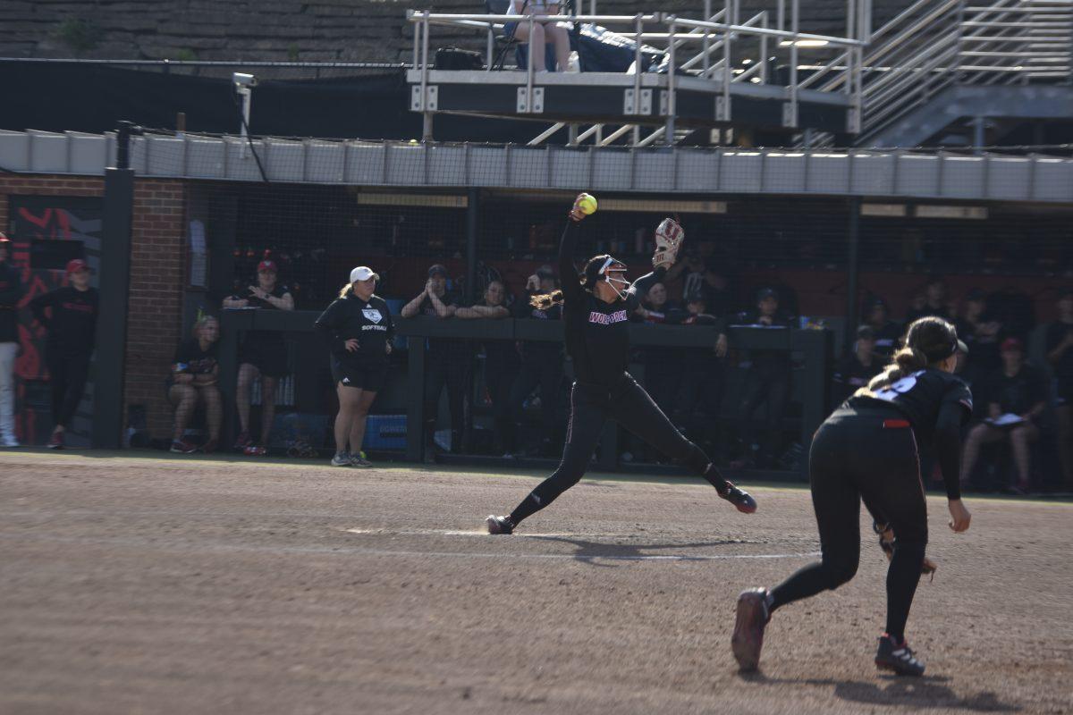 Freshman pitcher Kayla Fekel rolls their foot while winding up for a pitch at the Dali Softball Stadium against Presbyterian on Saturday, April 20, 2024. NC State won against Presbyterian 9-0 in five innings.