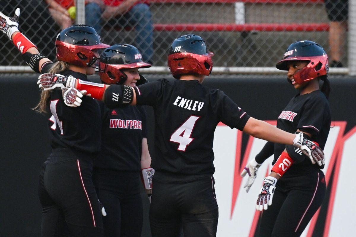 Sophomore utility player Makayla Marbury (right) celebrates with senior infielder Kaylee Lambrecht, junior infielder Taylor Ensley and freshman infielder Tori Ensley (left) after hitting a home run during the game against Elon at Dail Softball Stadium on Tuesday, April 2, 2024. Marbury had one at bat and two runs. NC state won the game 12-2.