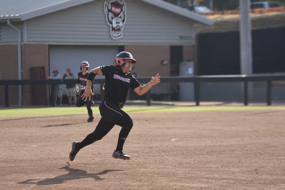 Freshman catcher Katie Raper runs to third base at the Dali Softball Stadium against Presbyterian on Saturday, April 20, 2024. Raper scored a run and a hit in three times at bat. NC State won against Presbyterian 9-0 in five innings.