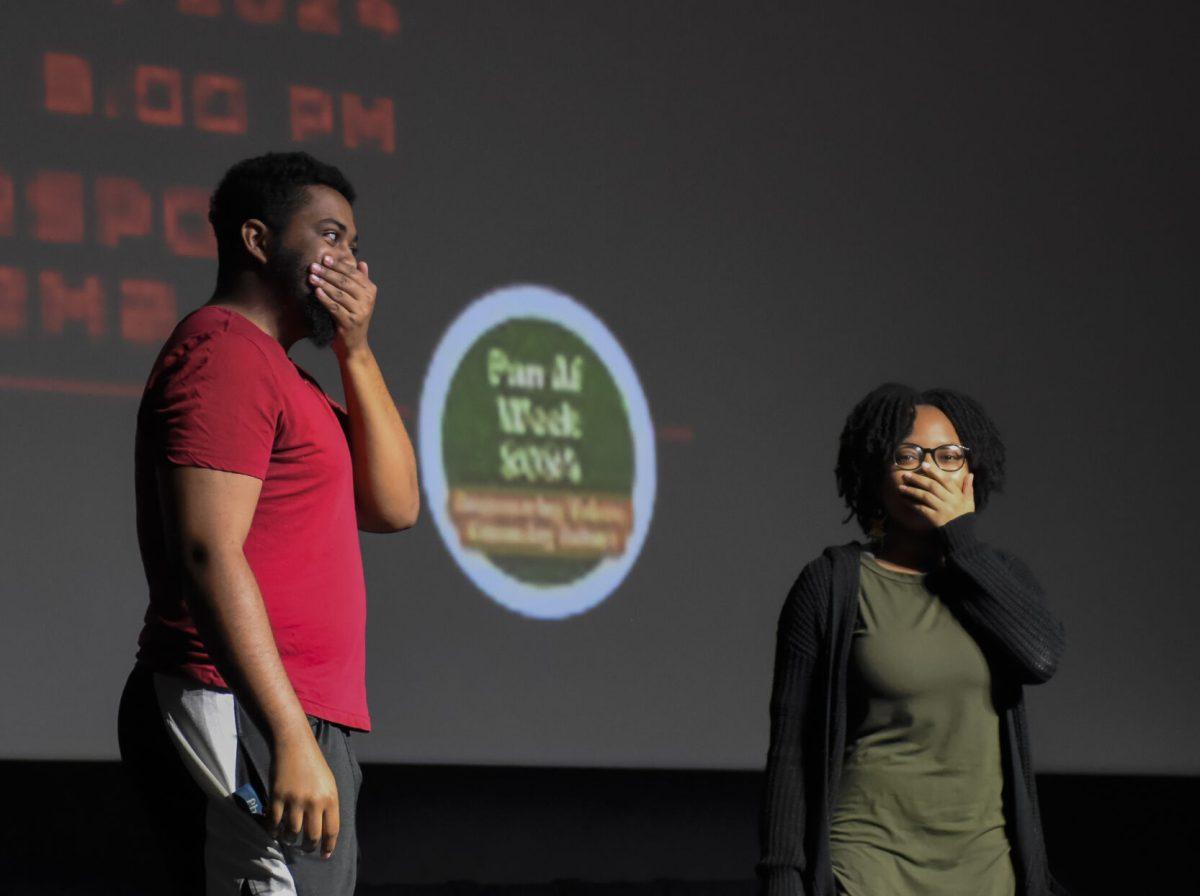 Dontae Miles, a fourth-year in zoology, and X cover their mouthes as they realize what game they signed up for at the Packed Out Game Night event in Witherspoon Student Cinema on Wednesday, April 10, 2024. Students participated in a guess the song game.