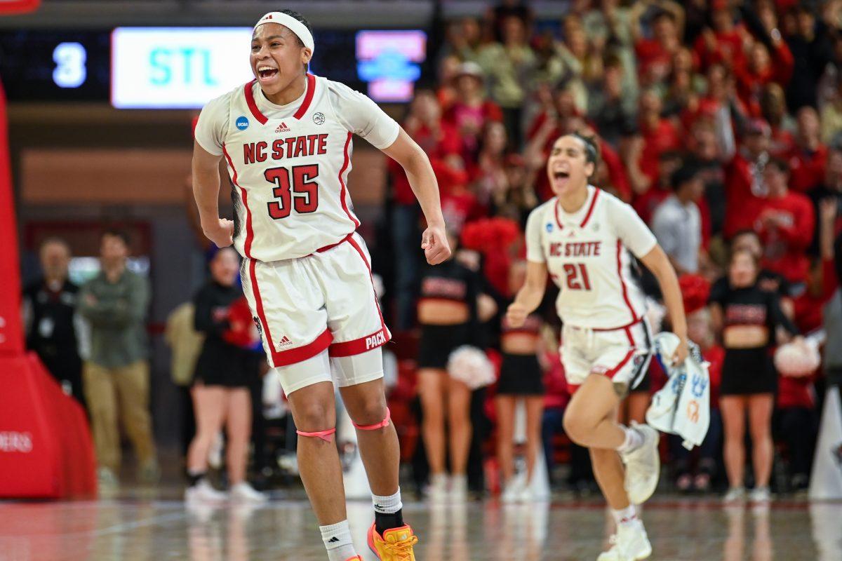 Freshman guard Zoe Brooks (left) and senior guard Madison Hayes (right) run onto the court after their teammate scored a point during the game against Tennessee in Reynolds Coliseum on Monday, March 25, 2024. The Wolfpack beat the Lady Volunteers 79-72.