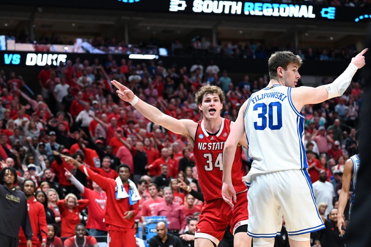 Junior forward Ben Middlebrooks and the crowd points in the direction of the possession during the NCAA Tournament Elite 8 game against Duke at American Airlines Center in Dallas on Sunday, March 31, 2024. Middlebrooks scored seven points and made five rebounds. NC State beat Duke 76-64 to advance to the Final Four.