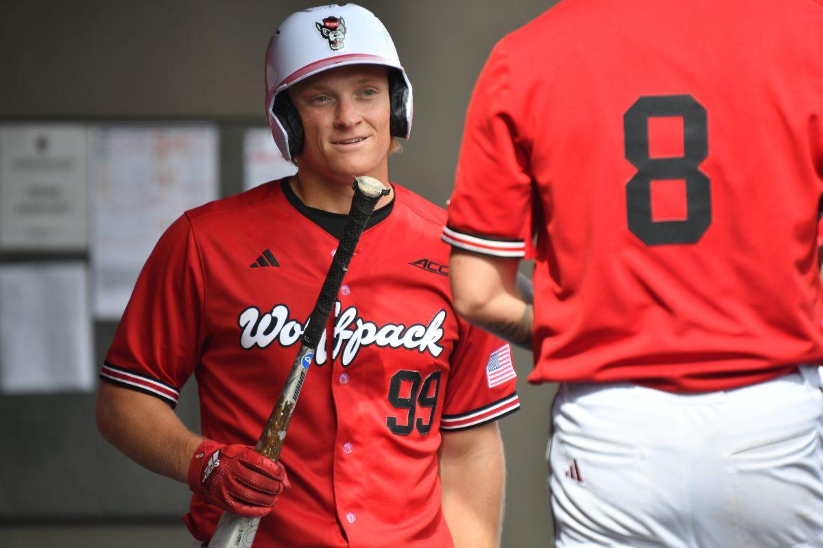 Graduate infielder Alec Makarewicz celebrates with the team in the dugout after making it home during the Wolfpack's final home game in the series against the Towson Tigers on Doak Field at Dail Park on Sunday, March 3, 2024. Makarewicz hit for three doubles, recording a .404 batting average and a RBI of five. The Wolfpack swept the Tigers, winning the final game in the series 14-4.
