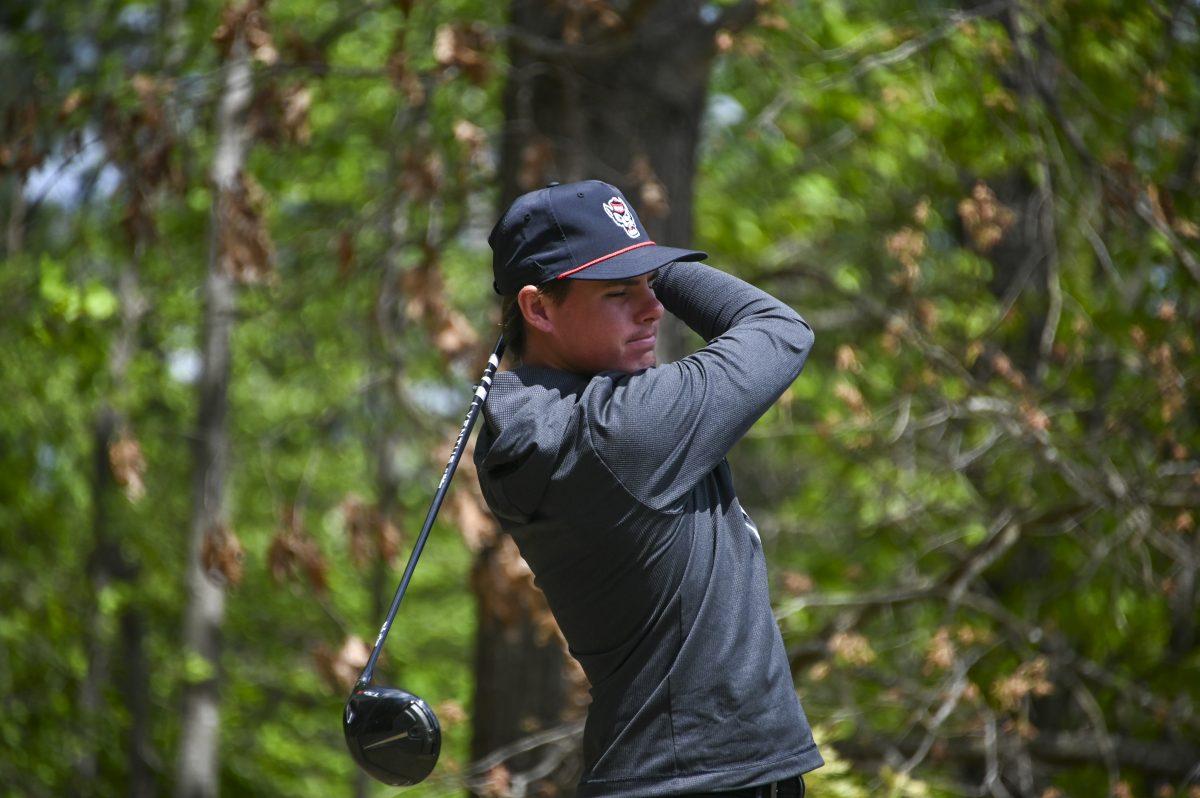 Junior Cade McLaughlin swings his club during the Stitch Intercollegiate golf match on Lonnie Poole Golf Course on Friday, April 12, 2024. McLaughlin finished the first round with 78 points.