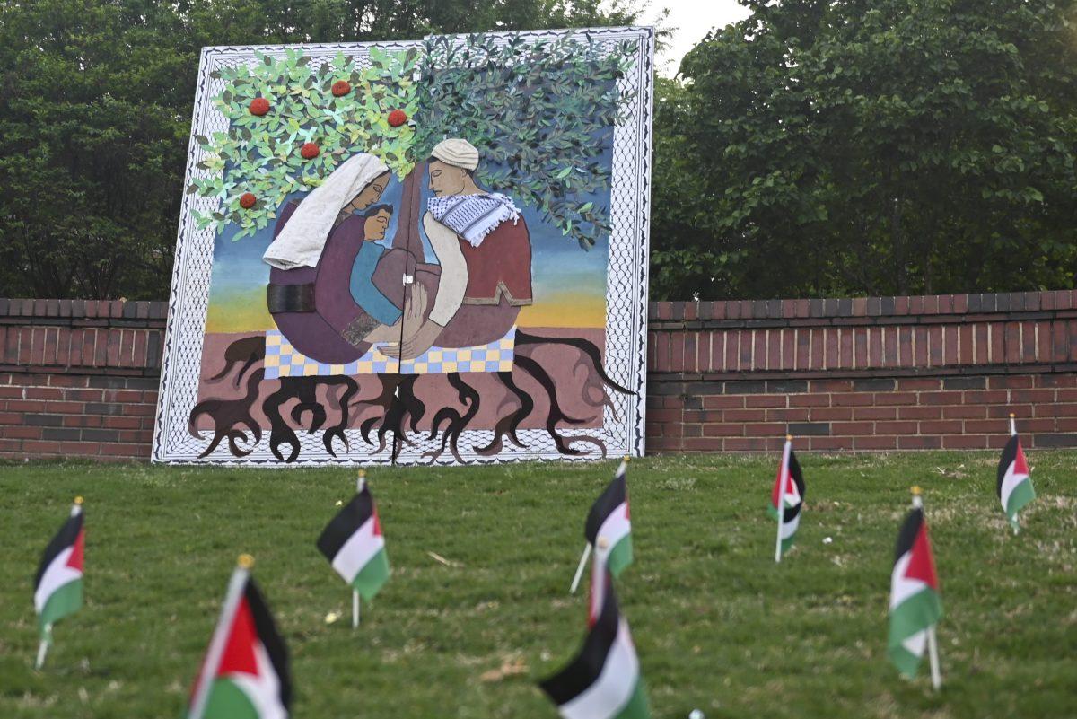 A painting overlooks Palestinian flags during the vigil for Gaza at the Court of the Carolinas on Friday, April 19, 2024. This event was held as a part of Palestine Solidarity Week that was held by NC State's chapter of Students for Justice in Palestine.