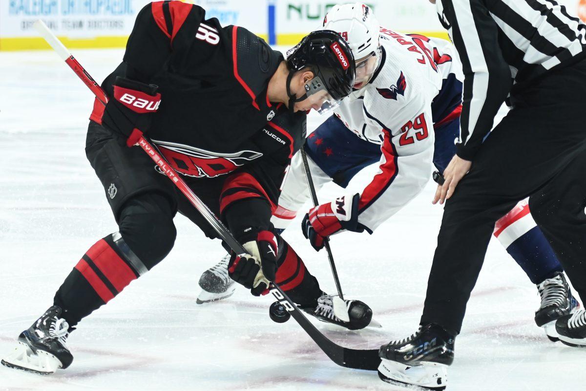Center Jack Drury battles for the puck during the Carolina Hurricanes game versus the Washington Capitals at PNC Arena on Friday, April 5, 2024. The Hurricanes beat the Capitals 4-2.