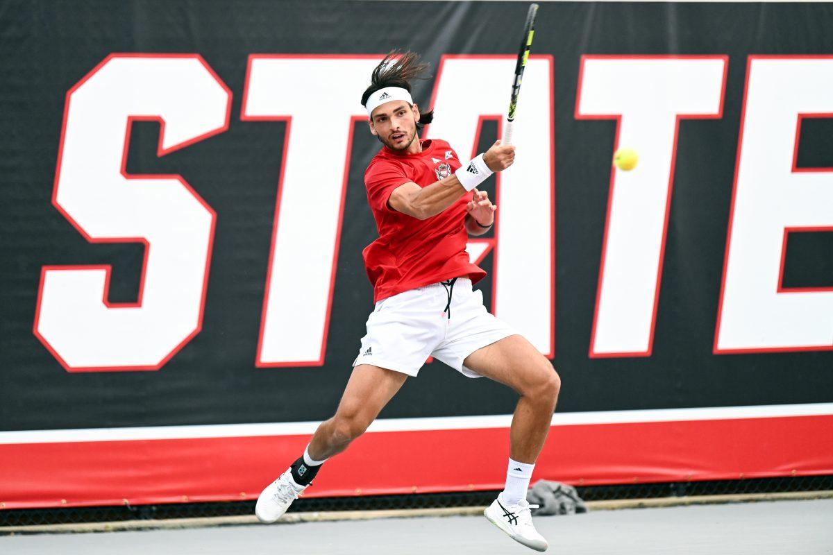 Junior Damien Salvestre forehands the ball during the match against UNC-Chapel Hill at Dail Outdoor Tennis Stadium on Friday, April 12, 2024. Salvestre won his singles match 6-3, 6-4. NC State beat Chapel Hill 4-0.