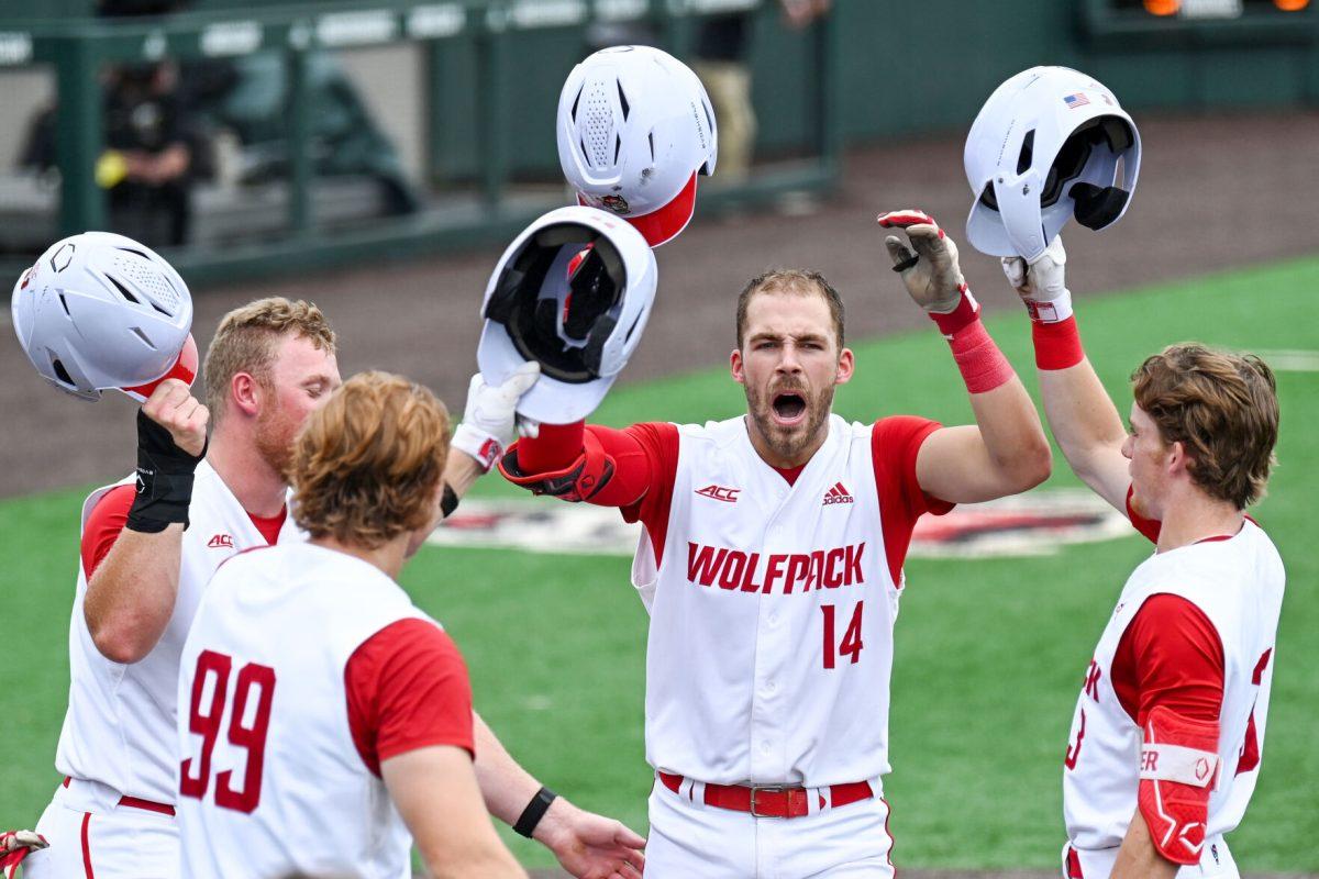Junior catcher Jacob Cozart celebrates with his teammates at home plate after hitting a home run during the game against Wake Forest at Doak Field at Dail Park on Saturday, May 18, 2024. Cozart recorded one run and three RBIs. NC State beat Wake Forest 9-6 and swept the series.