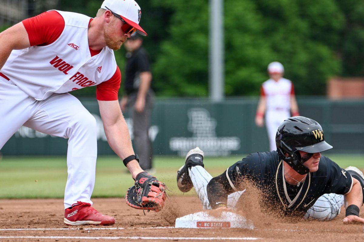 Graduate infielder Garrett Pennington attempts to catch a runner out during the game against Wake Forest at Doak Field at Dail Park on Saturday, May 18, 2024. Pennington recorded two hits and three RBIs. NC State beat Wake Forest 9-6 and swept the series.