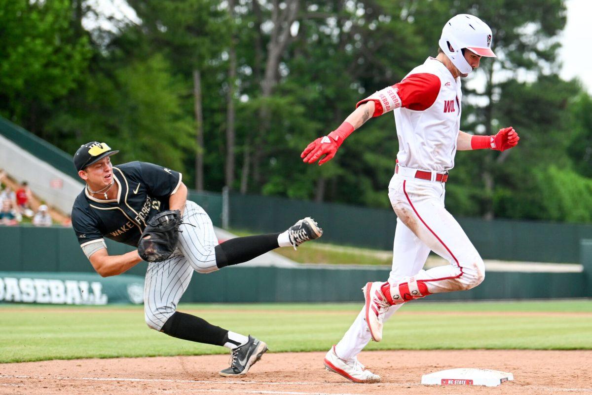 Sophomore outfielder Eli Serrano avoids being tagged out while running to first base during the game against Wake Forest at Doak Field at Dail Park on Saturday, May 18, 2024. Serrano recorded two hits and one RBI. NC State beat Wake Forest 9-6 and swept the series.