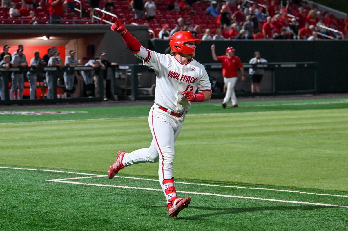 Freshman catcher Alex Sosa points to the sky after hitting a grand slam during the game against Wake Forest&#160;at Doak Field at Dail Park on Thursday, May 16, 2024. Sosa recorded two hits, two walks and four runs batted in. The Wolfpack defeated the Demon Deacons 14-3.