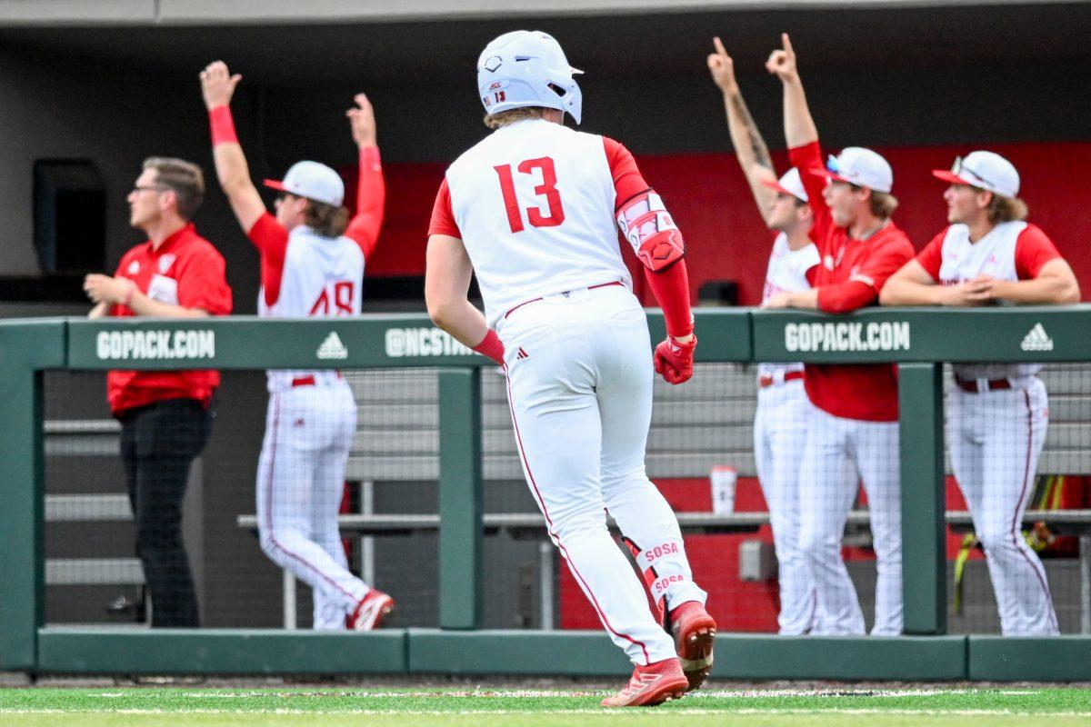 Freshman catcher Alex Sosa runs as his teammates celebrate after hitting a home run during the game against Wake Forest at Doak Field at Dail Park on Saturday, May 18, 2024. Sosa recorded two runs on two hits with two RBIs. NC State beat Wake Forest 9-6 and swept the series.