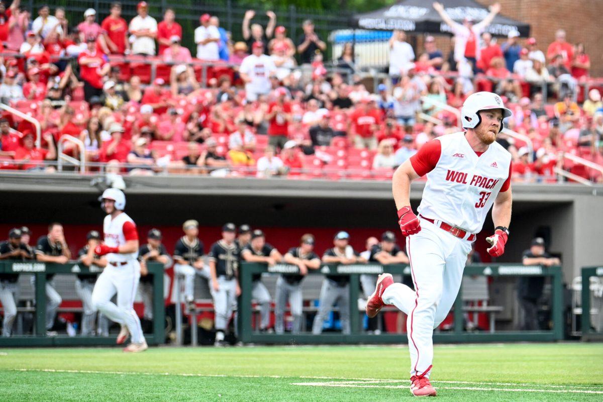 Graduate infielder Garrett Pennington runs to first base while batting a run in during the game against Wake Forest at Doak Field at Dail Park on Saturday, May 18, 2024. Pennington recorded two hits and three RBIs. NC State beat Wake Forest 9-6 and swept the series.