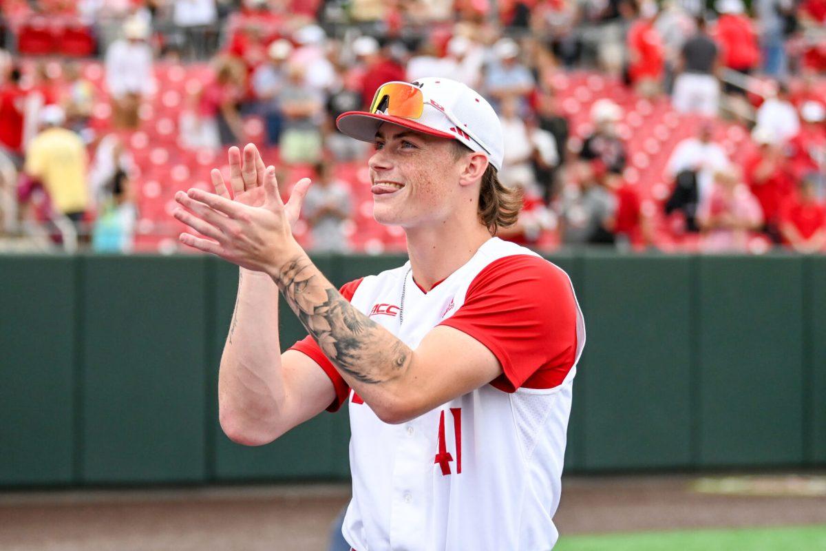 Freshman pitcher Jacob Dudan claps and smiles while looking into the crowd after the game against Wake Forest at Doak Field at Dail Park on Saturday, May 18, 2024. NC State beat Wake Forest 9-6 and swept the series.