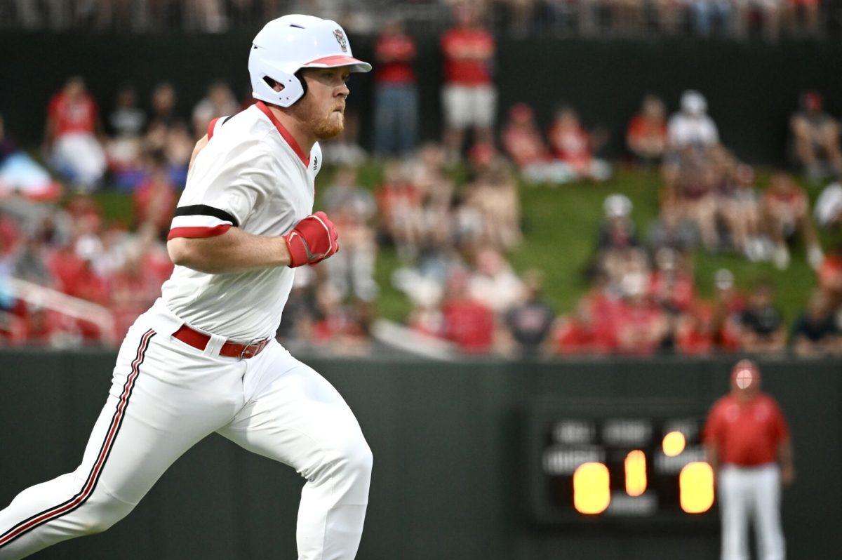 Graduate infielder Garrett Pennington runs to first base during the game against Wake Forest at Doak Field at Dail Park on Friday, May 17, 2024. NC State beat Wake Forest 2-1 to win the series.