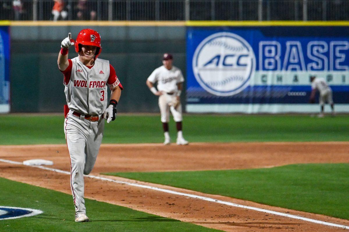Junior infielder Brandon Butterworth points to the crowd after hitting a home run during the ACC Tournament game against Virginia Tech at Truist Field in Charlotte on Wednesday, May 22, 2024. Butterworth scored two runs and recorded two RBIs. NC State beat Virginia Tech 19-9 in eight innings.