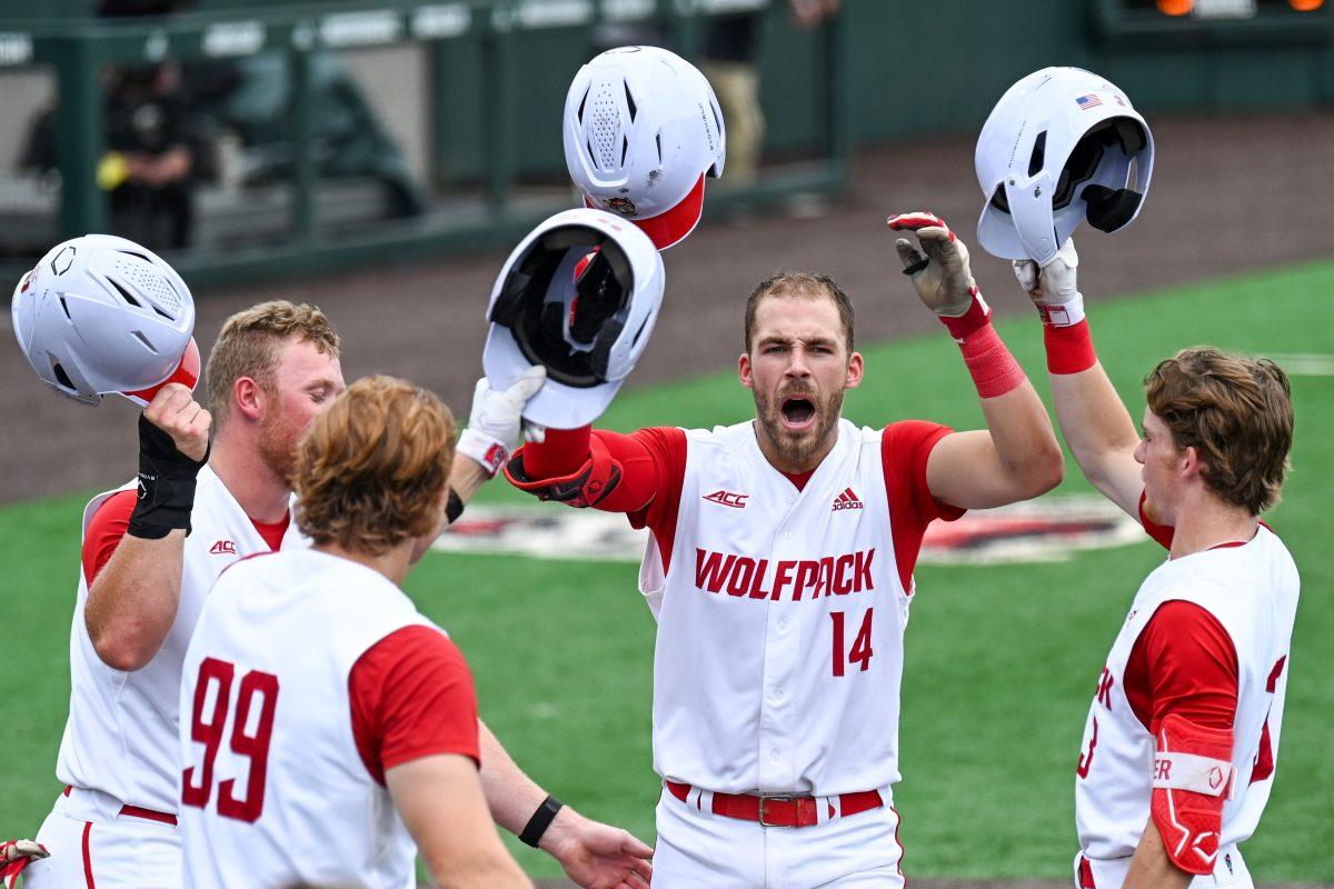 Junior catcher Jacob Cozart celebrates with his teammates at home plate after hitting a home run during the game against Wake Forest at Doak Field at Dail Park on Saturday, May 18, 2024. Cozart recorded one run and three RBIs. NC State beat Wake Forest 9-6 and swept the series.