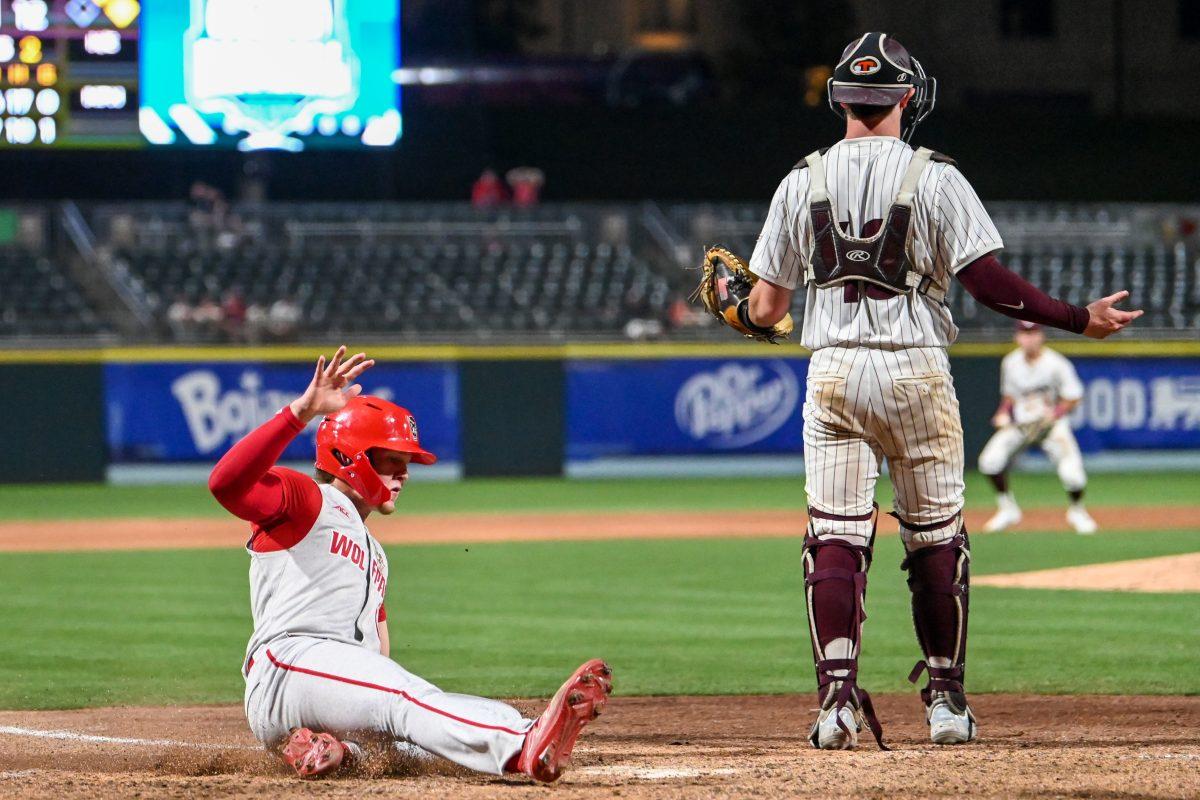 Freshman catcher Alex Sosa slides into home plate during the ACC Tournament game against Virginia Tech at Truist Field in Charlotte on Wednesday, May 22, 2024. Sosa hit one home run and recorded five RBIs. NC State beat Virginia Tech 19-9 in eight innings.