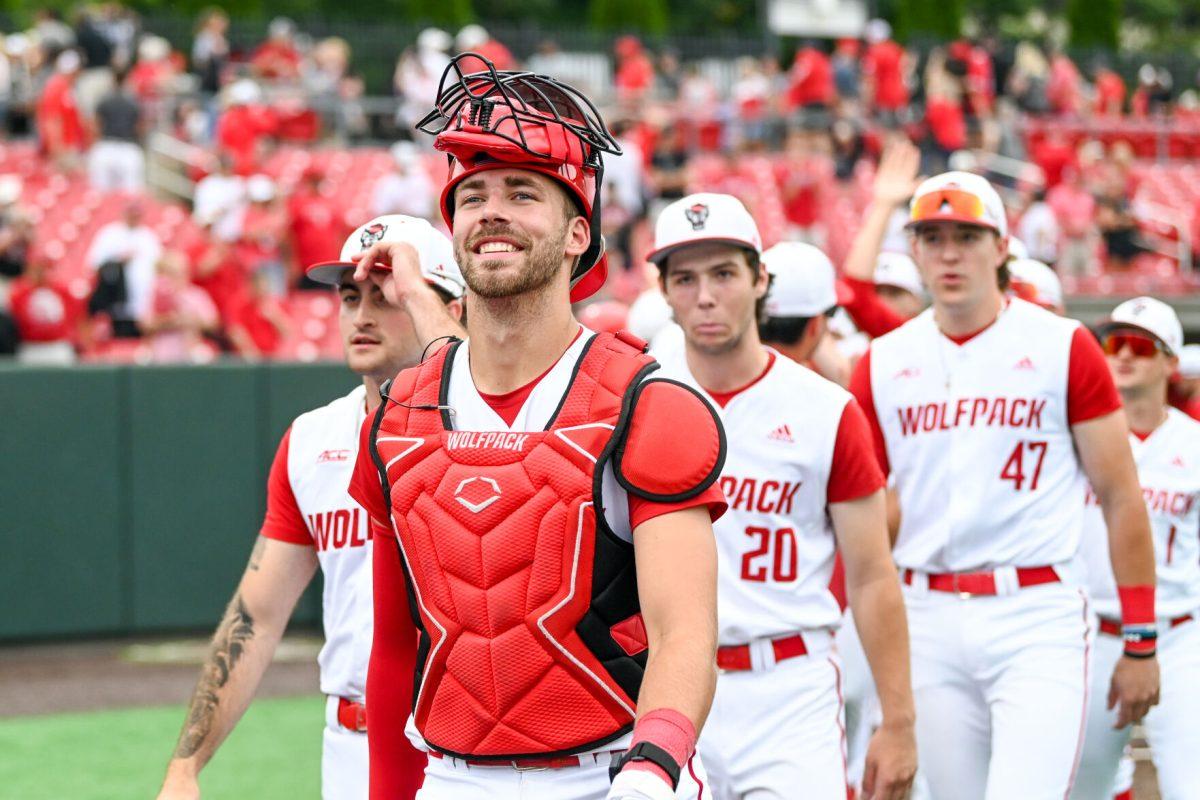 Junior catcher Jacob Cozart smiles while walking off the field during the game against Wake Forest at Doak Field at Dail Park on Saturday, May 18, 2024. Cozart recorded one run and three RBIs. NC State beat Wake Forest 9-6 and swept the series.