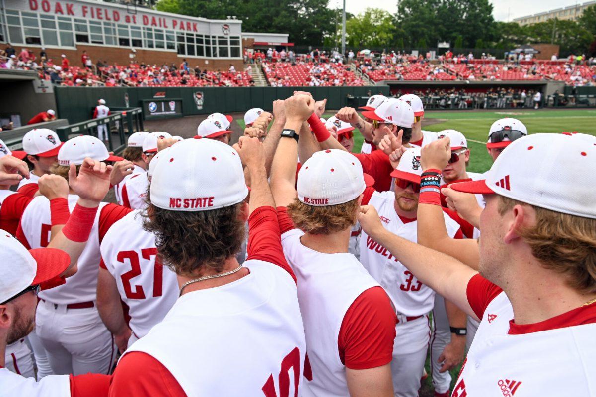 NC State huddles together before the Senior Day game against Wake Forest at Doak Field at Dail Park on Saturday, May 18, 2024. NC State beat Wake Forest 9-6 and swept the series.