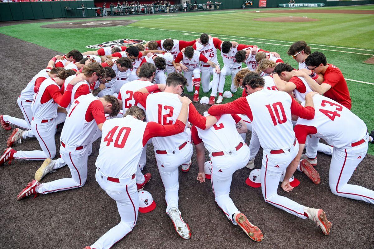 NC State huddles together before the Senior Day game against Wake Forest at Doak Field at Dail Park on Saturday, May 18, 2024. NC State beat Wake Forest 9-6 and swept the series.