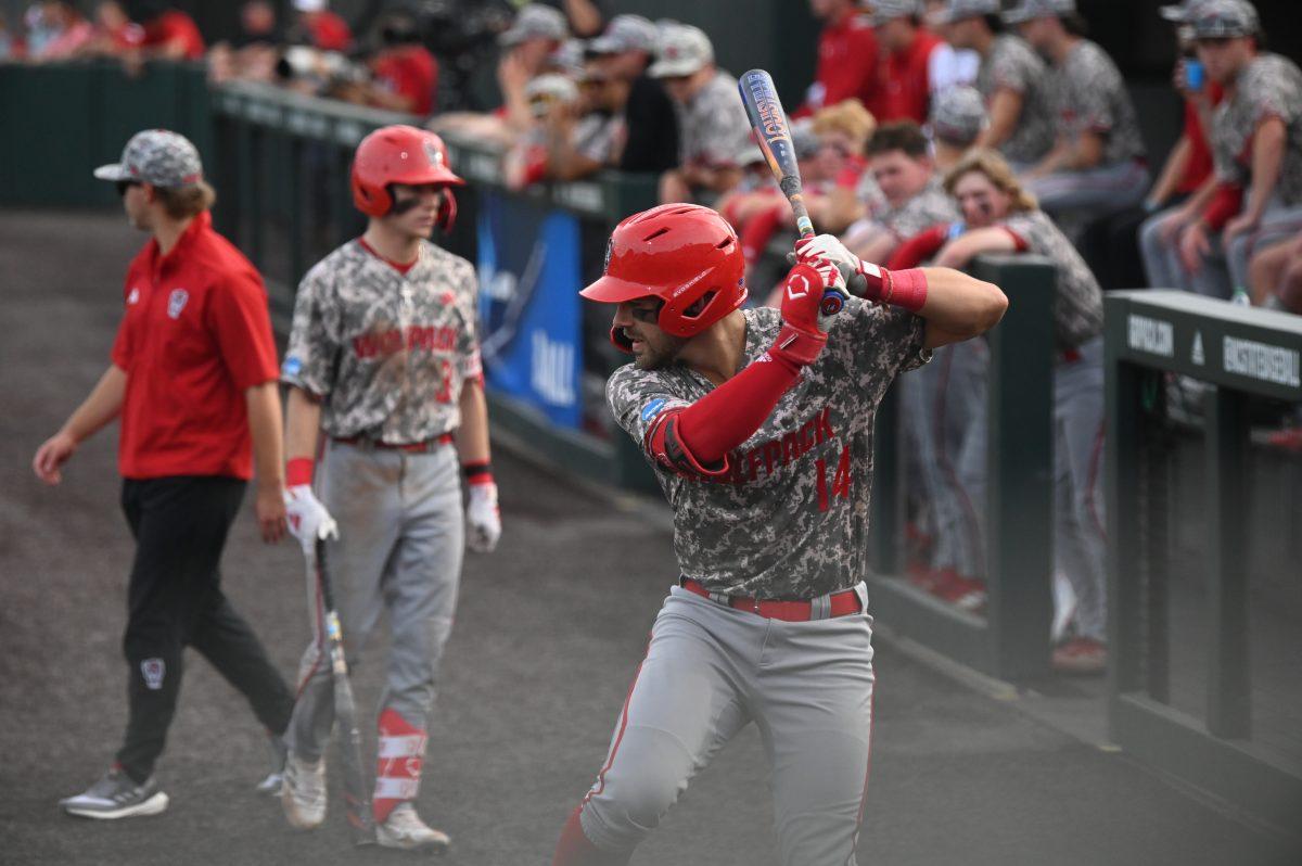 Junior catcher Jacob Cozart warms up before stepping into the batter's box during the NCAA Raleigh Regional final against the James Madison Dukes on Doak Field at Dail Park on Sunday, June 2, 2024. The Wolfpack beat the Dukes 5-3 to advance to the super regional round in Athens, Georgia.