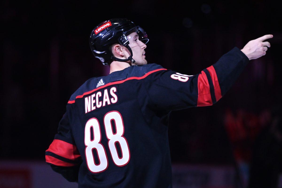 Center Martin Necas tosses a puck into the stands after the Carolina Hurricanes game versus the Washington Capitals at PNC Arena on Friday, April 5, 2024. Necas scored one goal for the Hurricanes. The Hurricanes beat the Capitals 4-2.